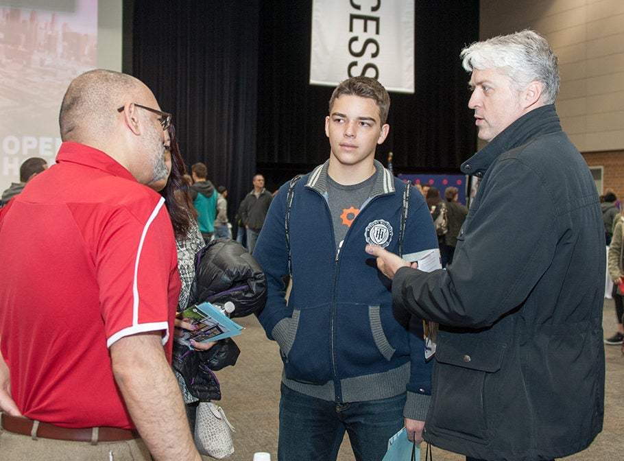 Visitors learning about UIC at Open House