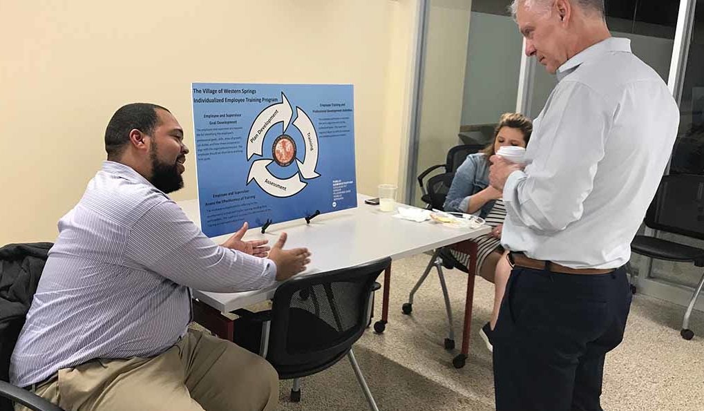 PA student presenting 2018 Capstone project to Public Administration faculty.