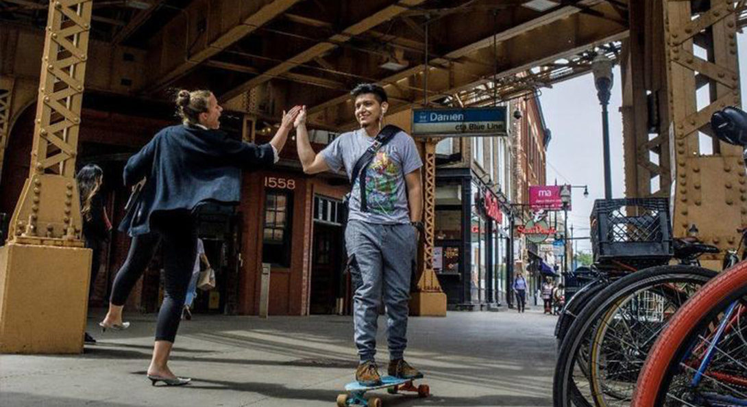 Commuter high fives a skate border in Wicker Park