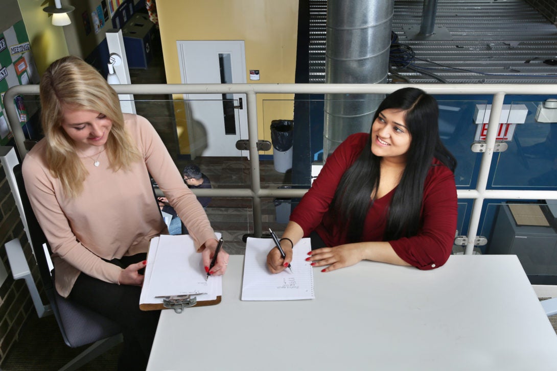 Two Students Studying and Taking Notes