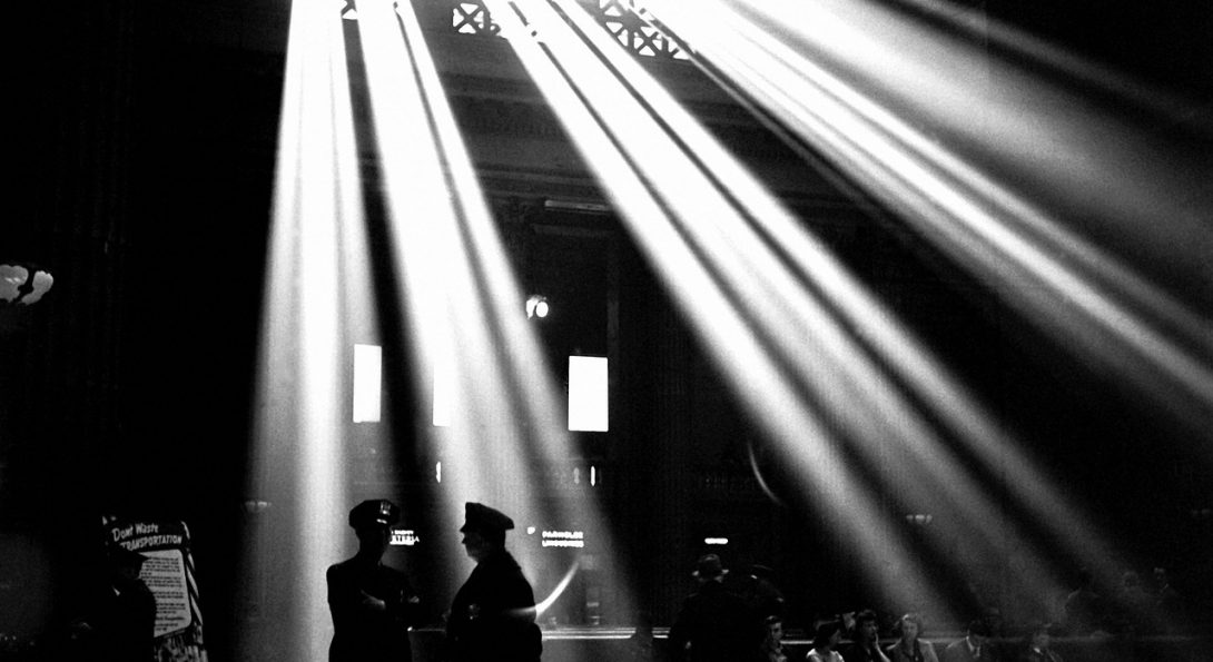 light shining through windows above two unidentified police officers