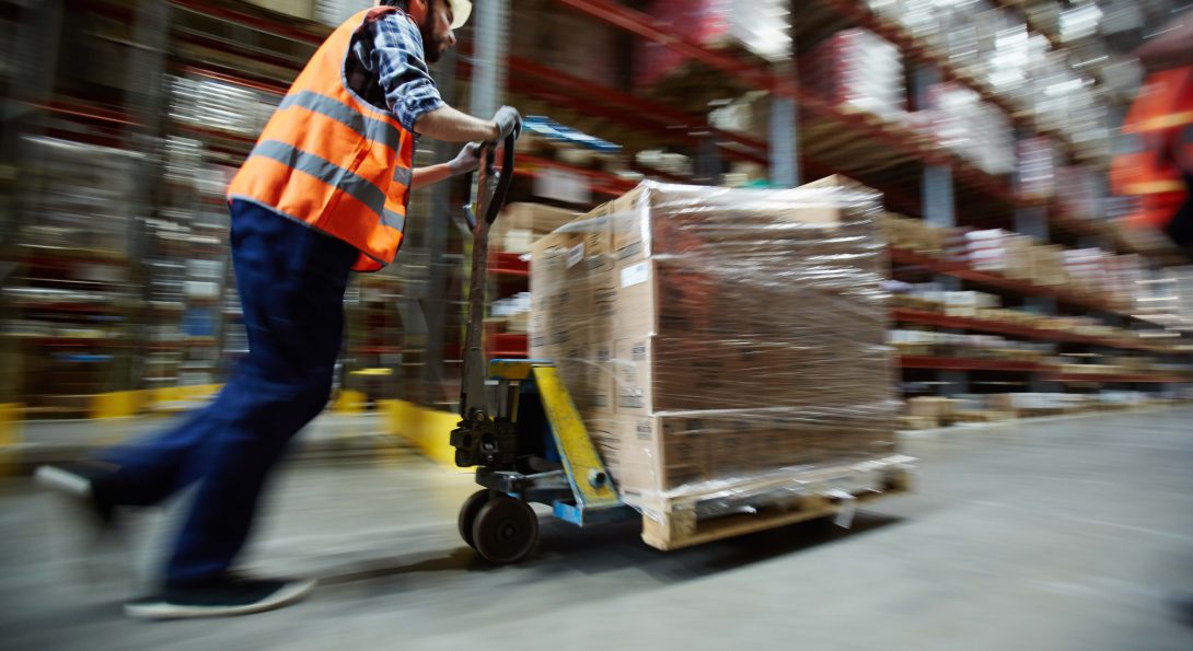 Warehouse employee pushing a cart.