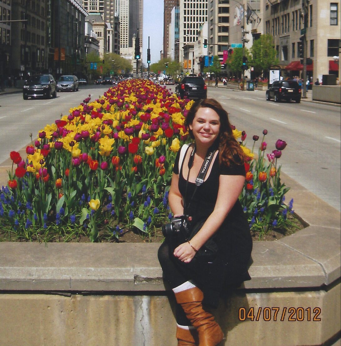 Anna Bachman sitting on a boulevard island of red and yellow tulips in Chicago