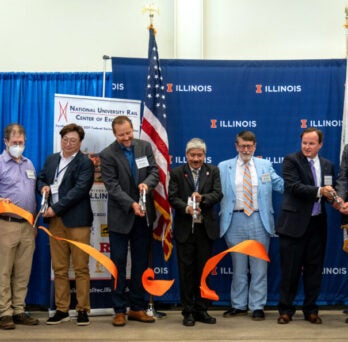 Federal and state representatives gathered for the official ribbon-cutting event on May 30, 2024 at UIUC. UTC Director P.S. Sriraj (third right with scissors) joined the cutting.
                  