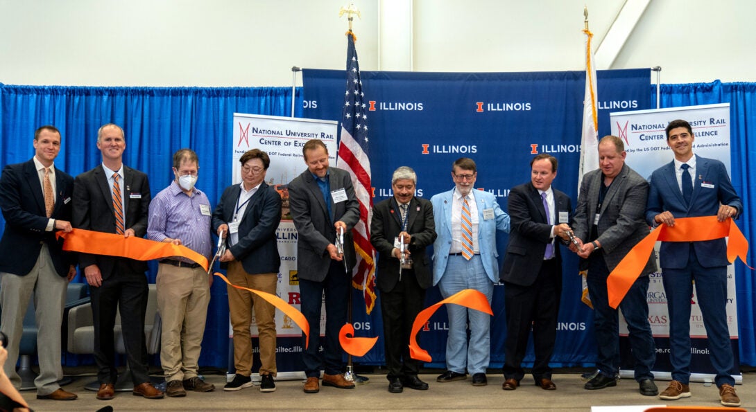 Federal and state representatives gathered for the official ribbon-cutting event on May 30, 2024 at UIUC. UTC Director P.S. Sriraj (third right with scissors) joined the cutting.