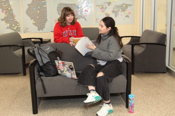 Two students in the Lower Level dressed in UIC teeshirts