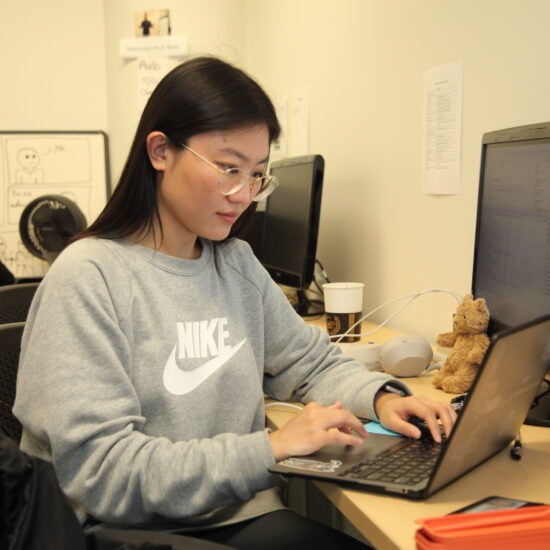 Student working on a laptop presumably scheduling an advising appointment.