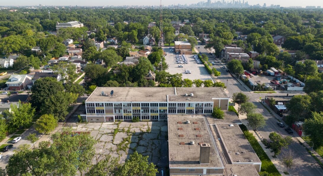 An aerial shot of Woods Academy in the Chicago neighborhood of Englewood. The Chicago skyline is in the distance.